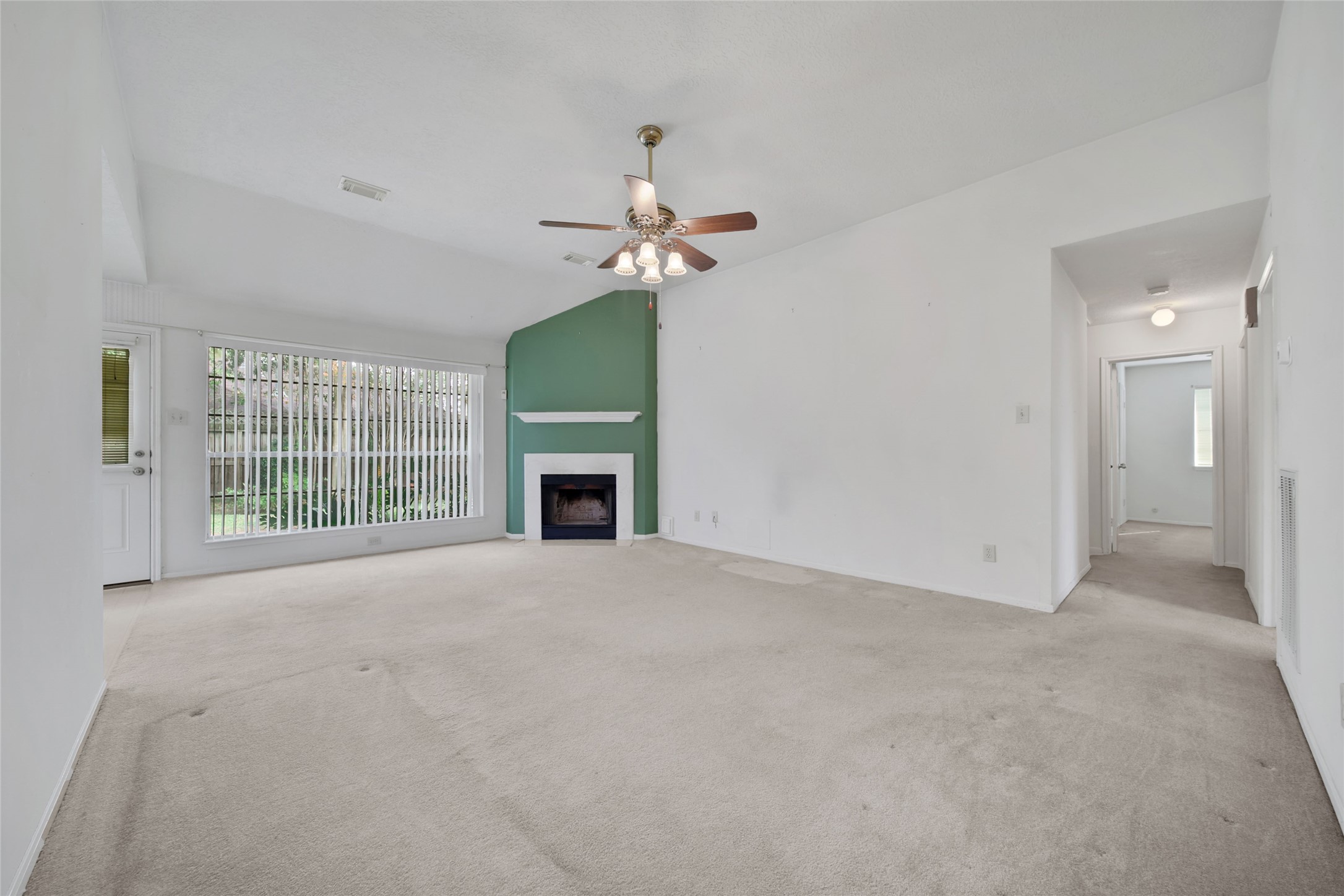 19110 Timber Way Drive Humble, TX 77346 - Photo 7 of 24 a view of an empty room with a fireplace and a window