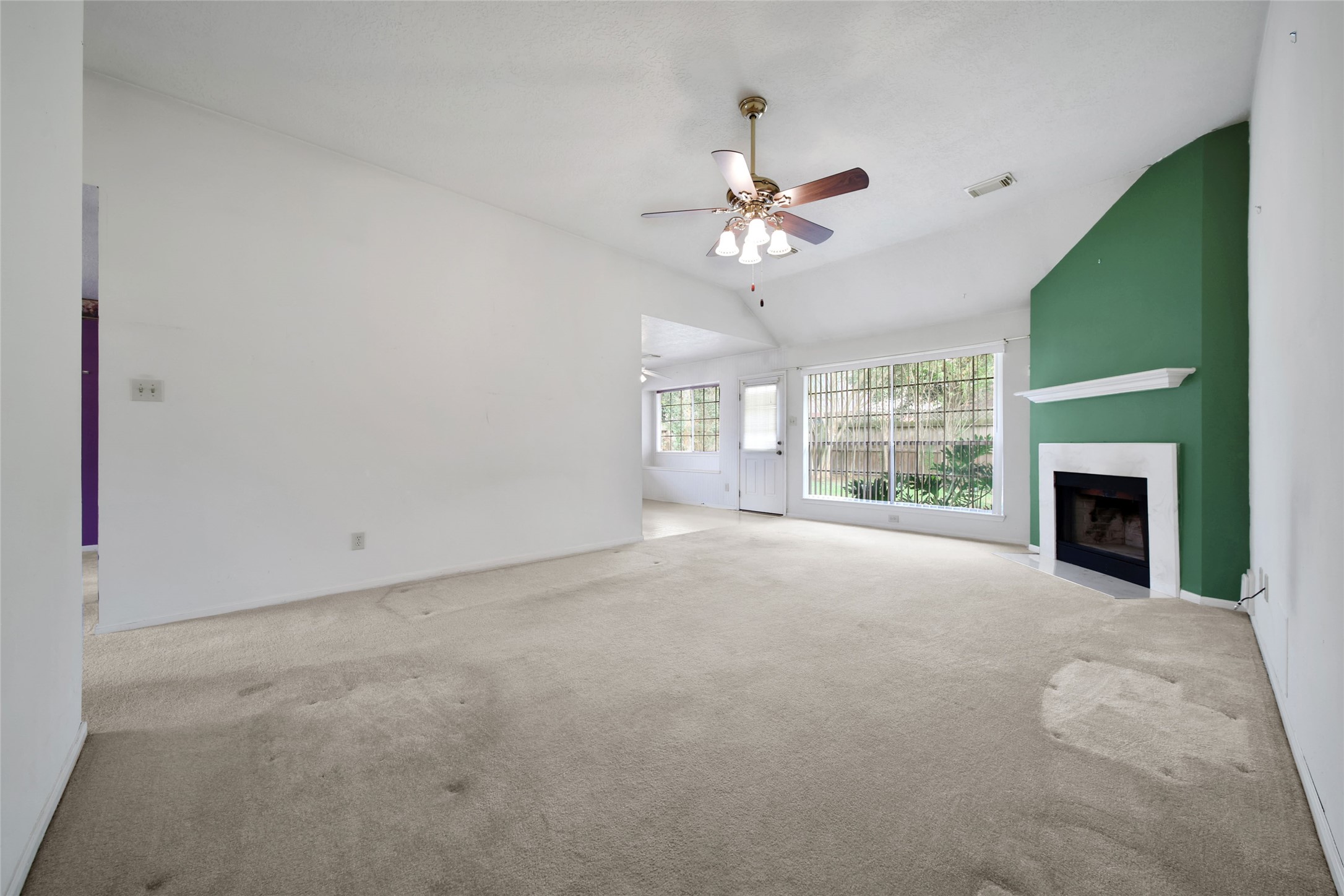 19110 Timber Way Drive Humble, TX 77346 - Photo 8 of 24 a view of an empty room with a fireplace and a window