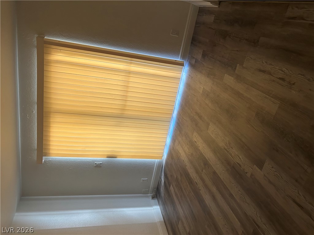 1852 North Decatur Boulevard, Unit 103 Las Vegas, NV 89108 - Photo 6 of 10 Natural light illuminates rich wood flooring and pristine baseboards, enhancing the inviting atmosphere.
