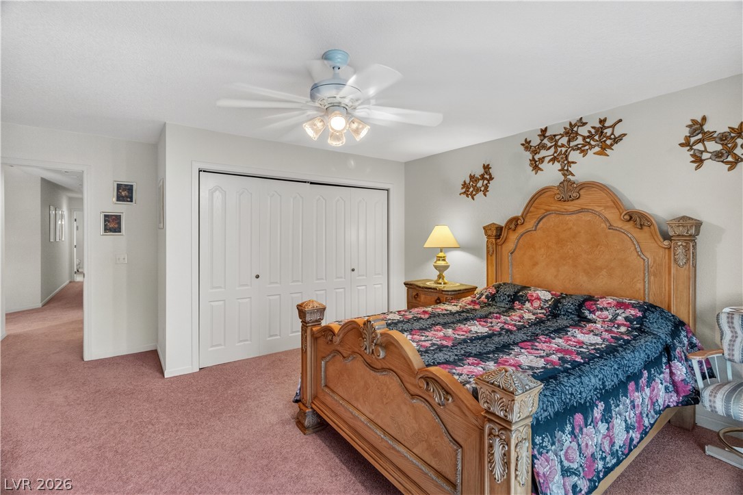 2055 Cholla Way Laughlin, NV 89029 - Photo 22 of 87 A comforting retreat, this bedroom offers plush carpeting and ample storage with built-in closet doors.