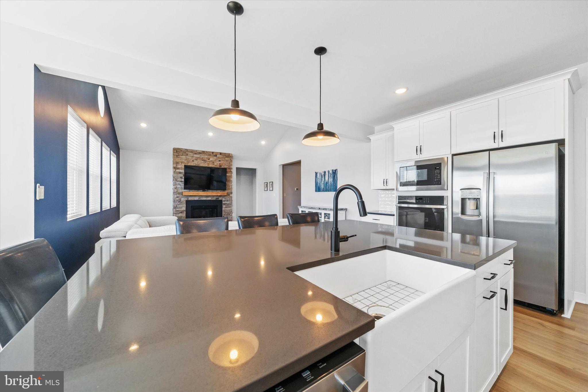 208 South Rdg Brk Drive Felton, DE 19943 - Photo 19 of 44 a large kitchen with kitchen island a large counter top a sink appliances and cabinets