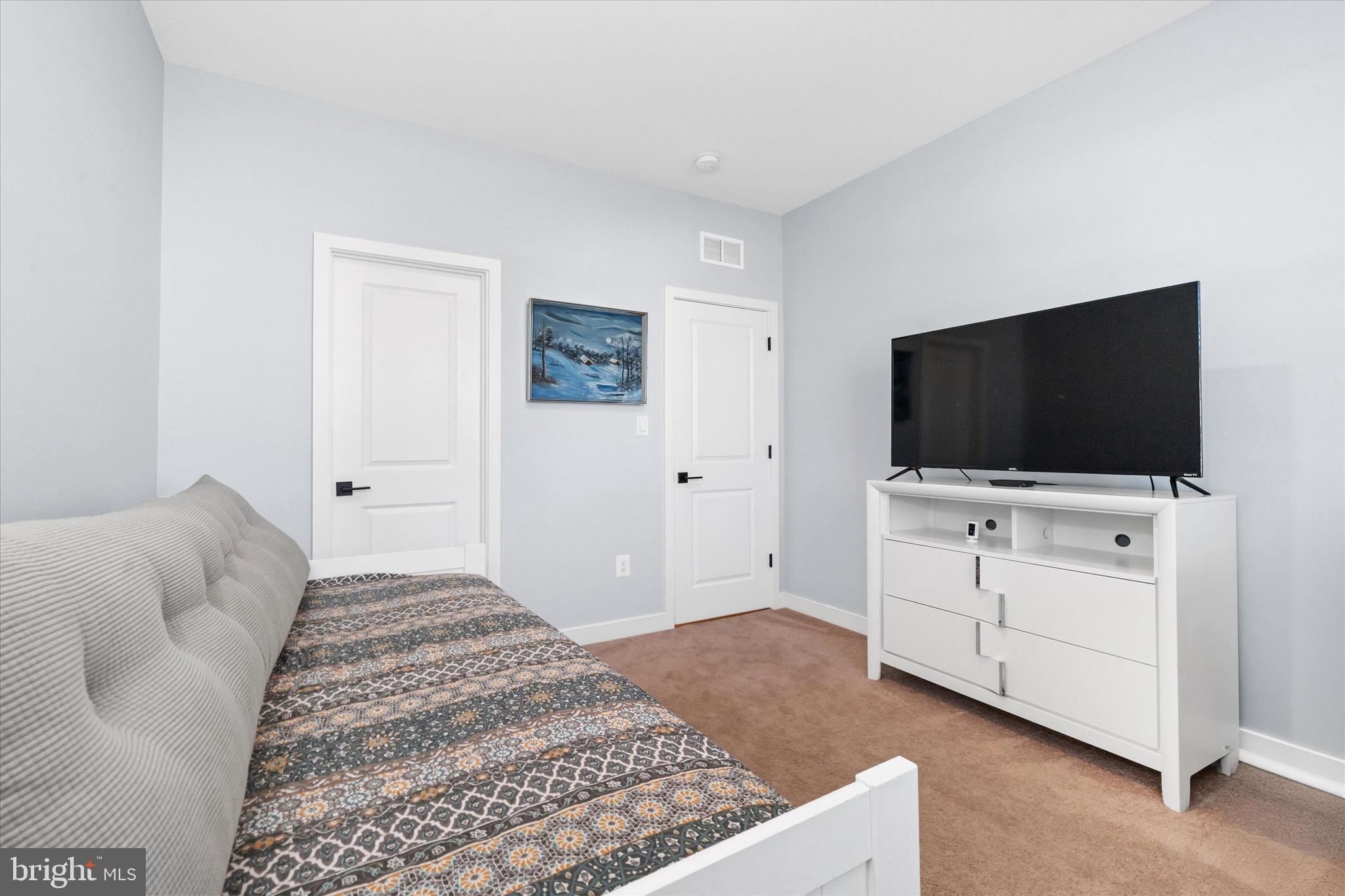 208 South Rdg Brk Drive Felton, DE 19943 - Photo 30 of 44 a bedroom with a bed and a flat screen tv