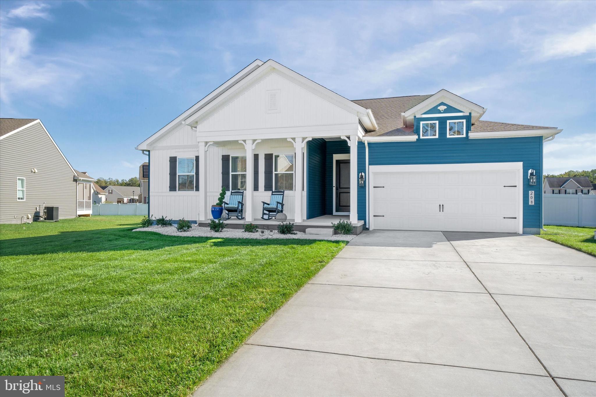 208 South Rdg Brk Drive Felton, DE 19943 - Photo 39 of 44 a view of a white house with a yard and potted plants