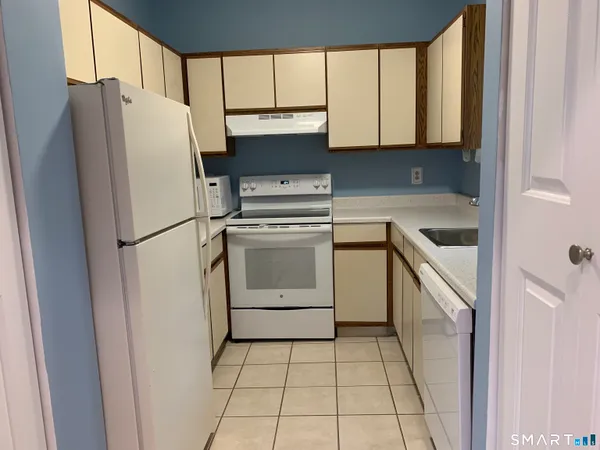 a white toilet and tub sitting next to a bathroom sink