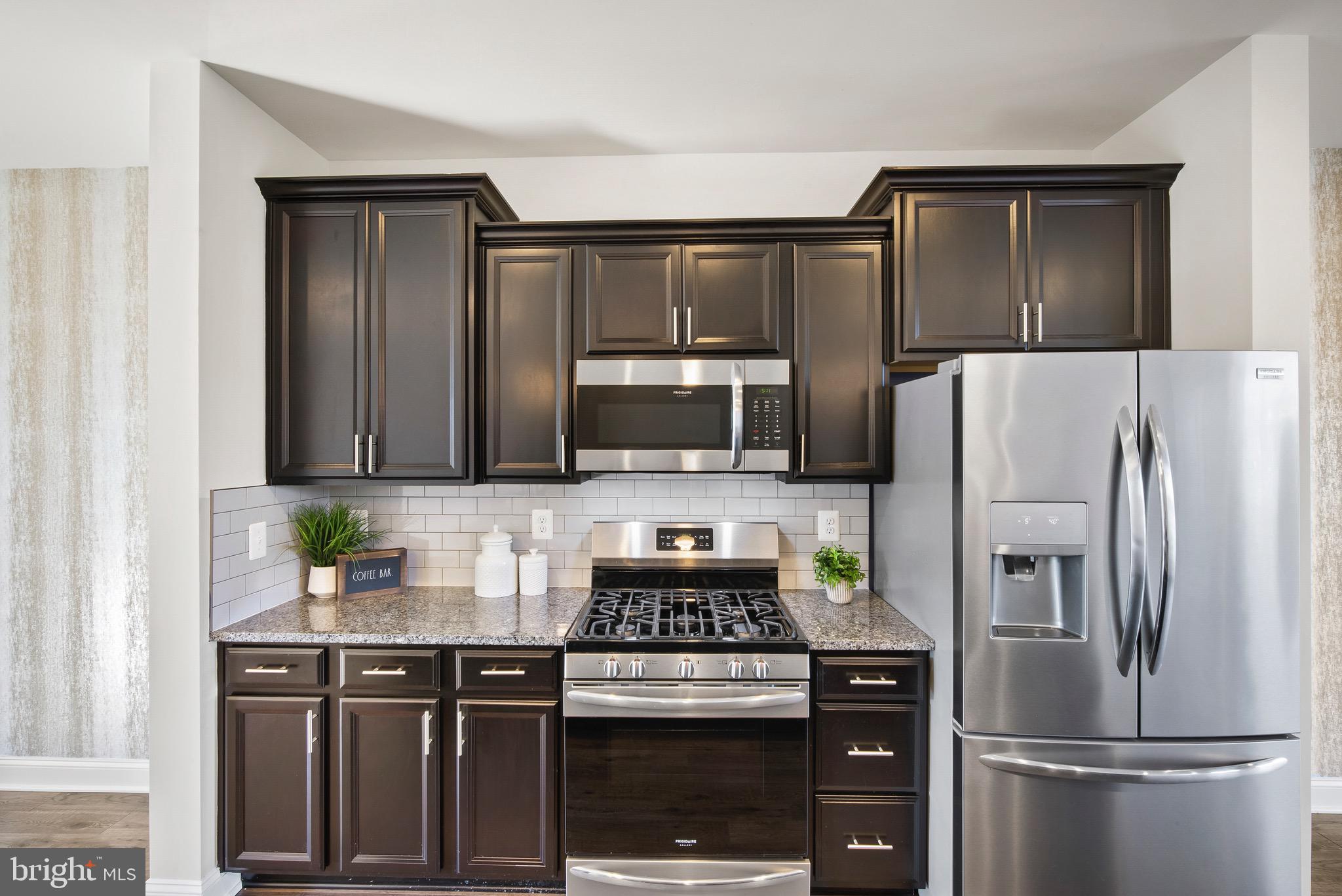 7012 Rackham Way Hanover, MD 21076 - Photo 4 of 46 Granite Countertops | 42" Espresso Cabinetry.