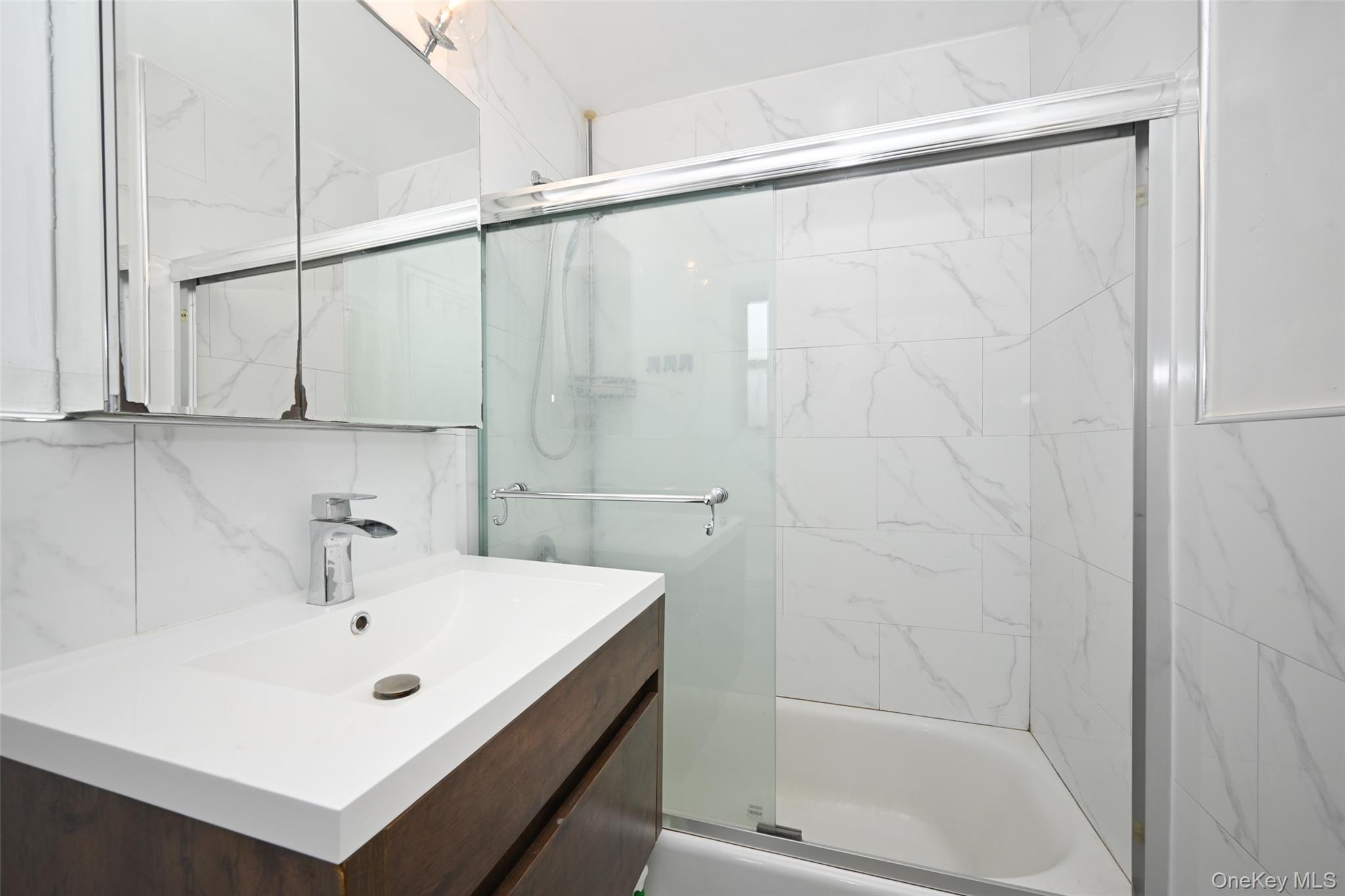 150-30 71st Avenue, Unit 2F Queens, NY 11367 - Photo 12 of 19 Bathroom featuring enclosed tub / shower combo and vanity