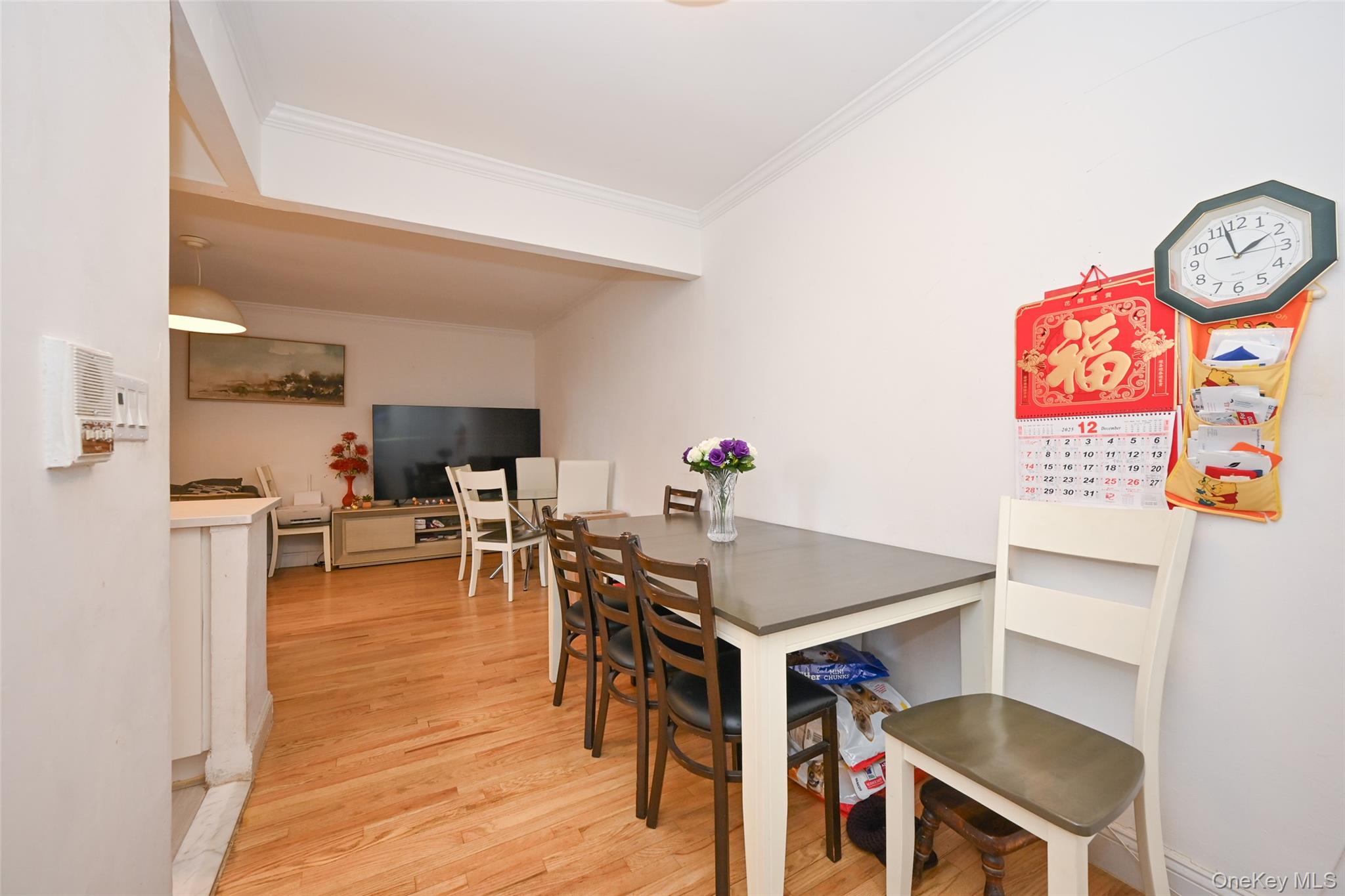 150-30 71st Avenue, Unit 2F Queens, NY 11367 - Photo 10 of 19 Dining area featuring ornamental molding and light wood finished floors