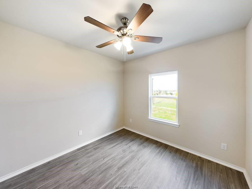 2910 Town Square Avenue, Unit 2103 Bryan, TX 77802 - Photo 9 of 9 wooden floor in an empty room with a window