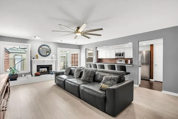 a living room with furniture a fireplace and a window
