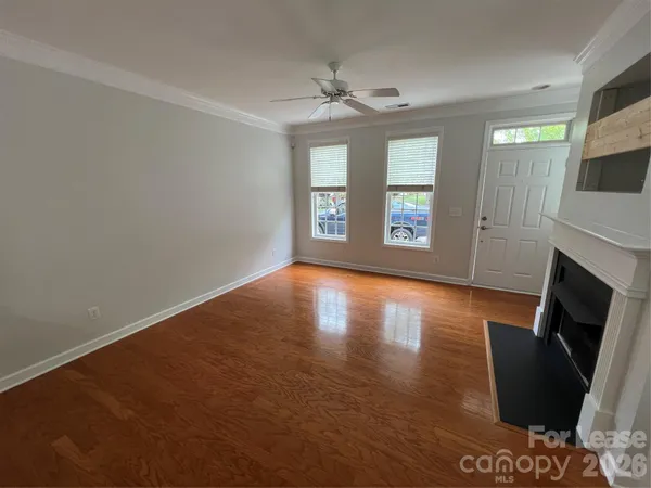 wooden floor in an empty room with a fireplace