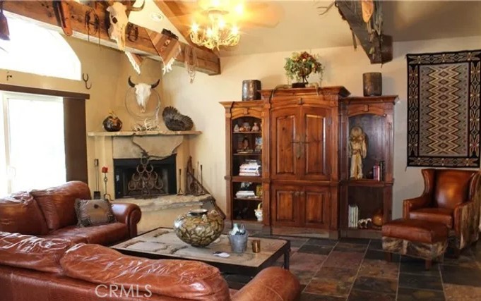 4937 Sweetgrass Lane Bonsall, CA 92003 - Photo 15 of 33 a living room with furniture a fireplace and a chandelier