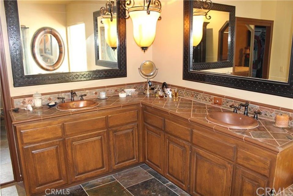 4937 Sweetgrass Lane Bonsall, CA 92003 - Photo 19 of 33 a bathroom with a sink and a mirror