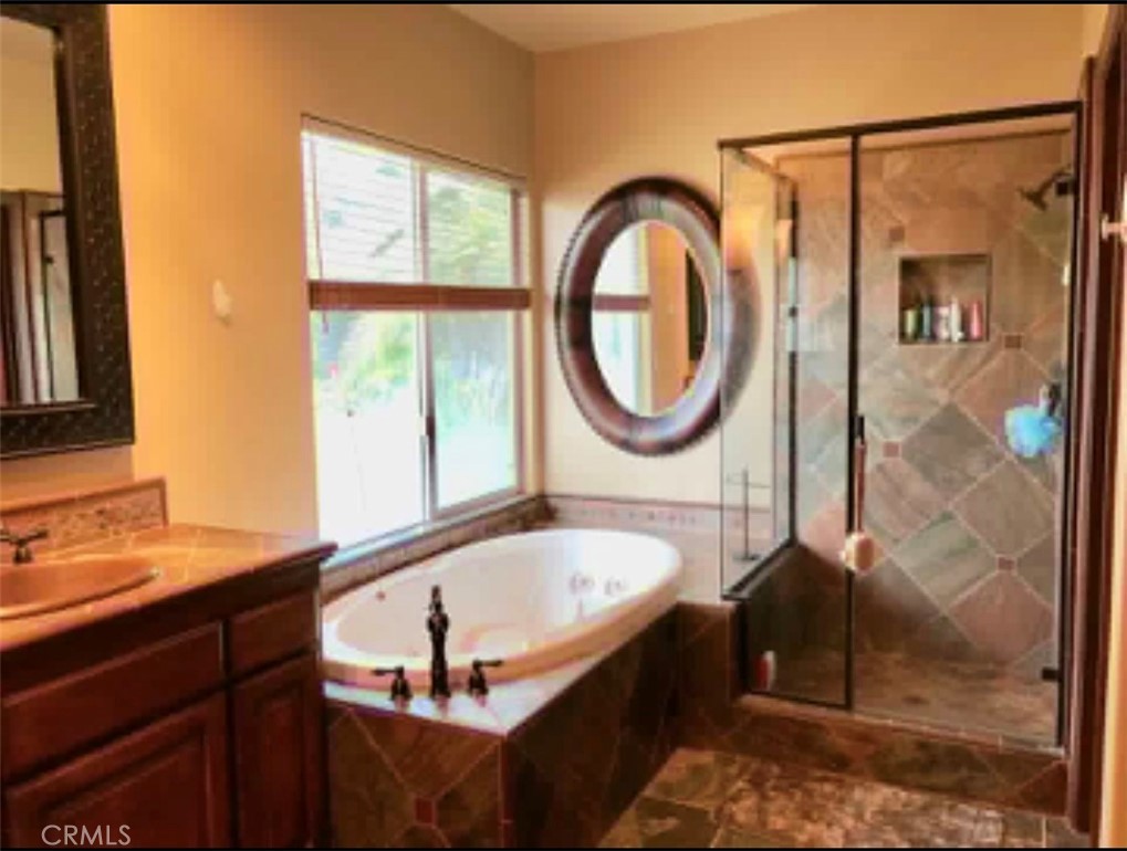 4937 Sweetgrass Lane Bonsall, CA 92003 - Photo 21 of 33 a bathroom with a sink a bathtub and a shower