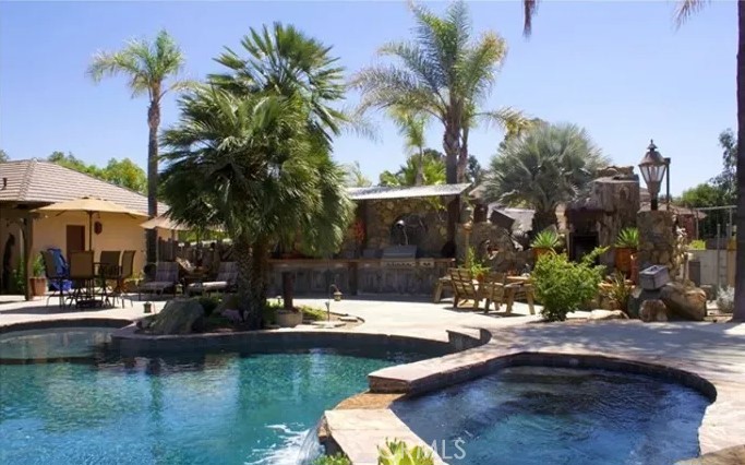 4937 Sweetgrass Lane Bonsall, CA 92003 - Photo 27 of 33 a swimming pool with outdoor seating and yard