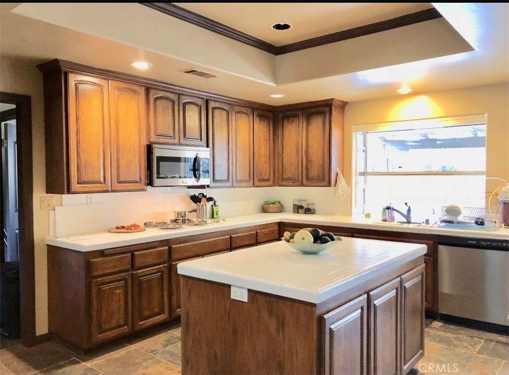 4937 Sweetgrass Lane Bonsall, CA 92003 - Photo 9 of 33 a kitchen with a sink a stove and cabinets