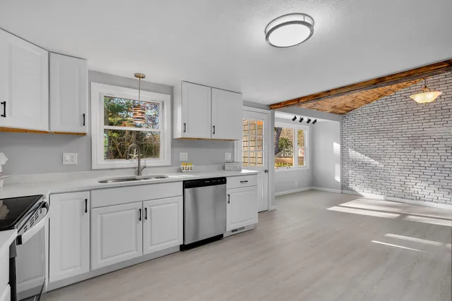 a kitchen with sink cabinets and window