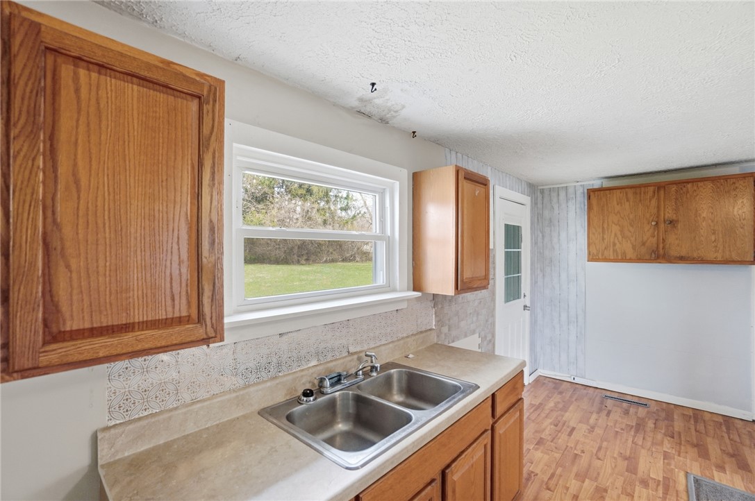 1166 West Sparrow Road Springfield, OH 45502 - Photo 22 of 40 This kitchen offers a practical layout with direct outdoor access and views of green space.
