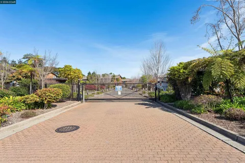 a view of a brick house with a small backyard