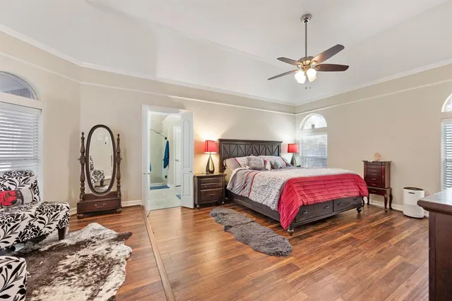 a spacious bedroom with a bed dresser and a window