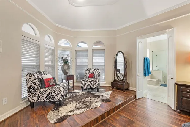 a living room with furniture chess floor and a large window