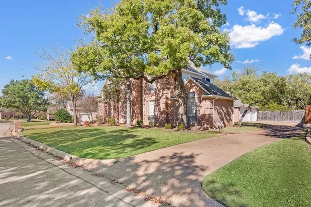 a view of a park with large trees