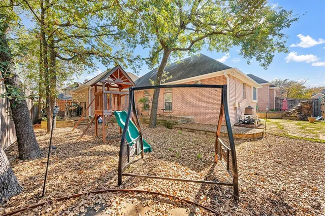 a view of a house with a tree in the yard