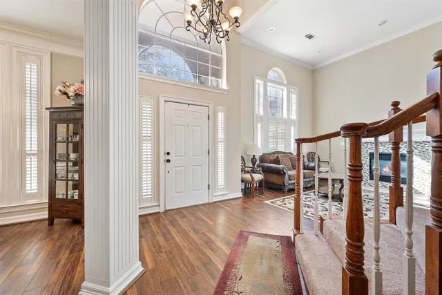 a living room with furniture and a chandelier