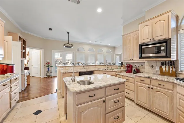 a kitchen with stainless steel appliances granite countertop a sink and cabinets