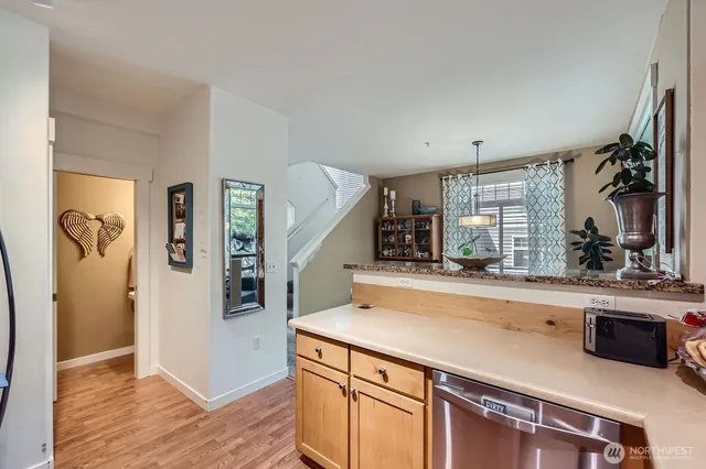 a view of a kitchen with cabinets and wooden floor