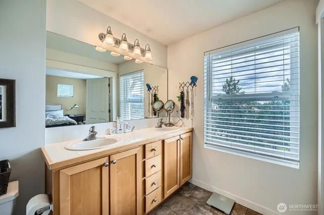 a bathroom with a sink a vanity and a mirror