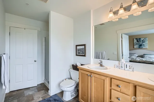a bathroom with a sink a toilet and a mirror
