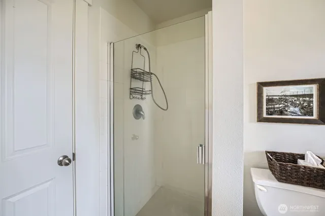 a bathroom with a toilet and shower