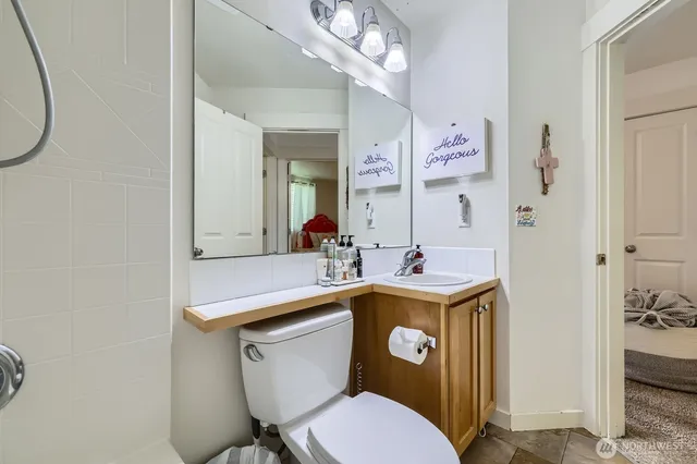a bathroom with a toilet sink and mirror