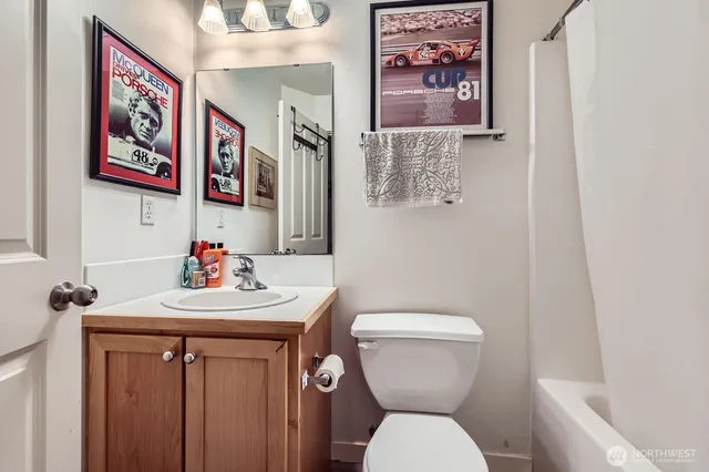 a bathroom with a toilet a sink and a mirror