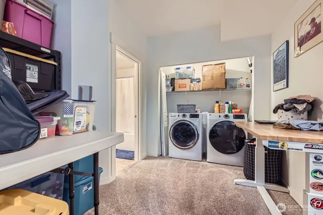 a utility room with sink dryer and washer
