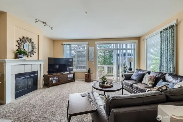 a living room with furniture a fireplace and a flat screen tv