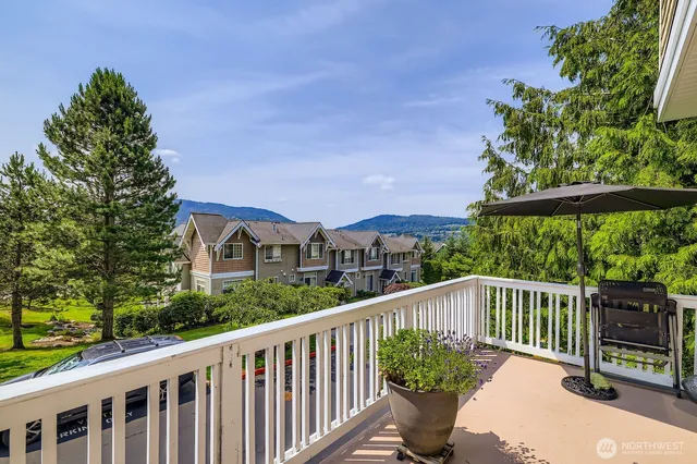 a view of a two chairs in the balcony