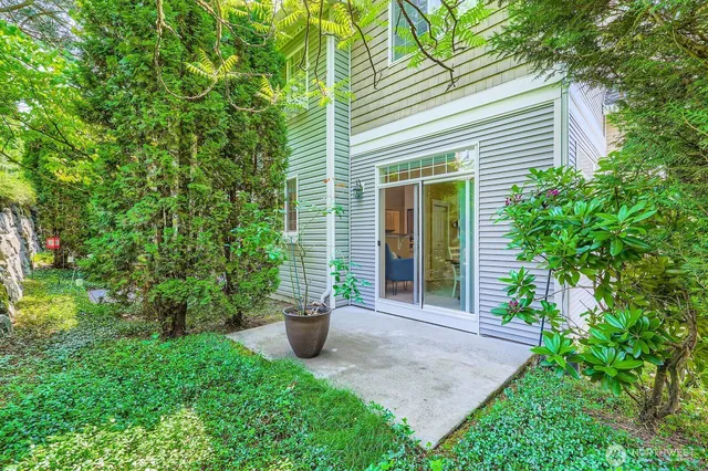 a view of a house with porch and garden