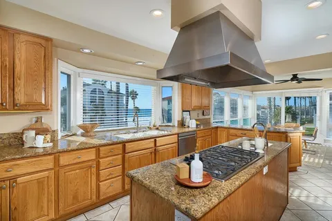 a kitchen with sink stove and cabinets