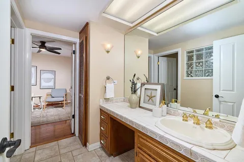 a en suite bathroom with a double vanity sink a mirror and a shower