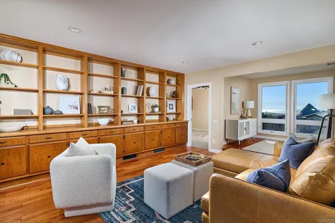a living room with furniture a rug and a window