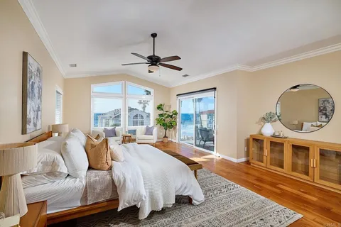 a spacious bedroom with a bed a window and couch