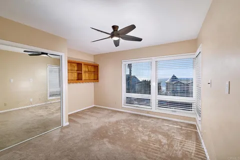 a view of a livingroom with a ceiling fan and window