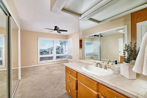 a bathroom with a granite countertop sink mirror and
