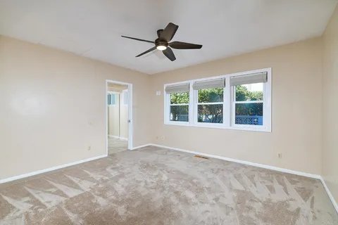 a view of empty room with ceiling fan