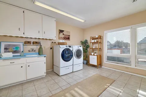 a utility room with sink dryer and washer