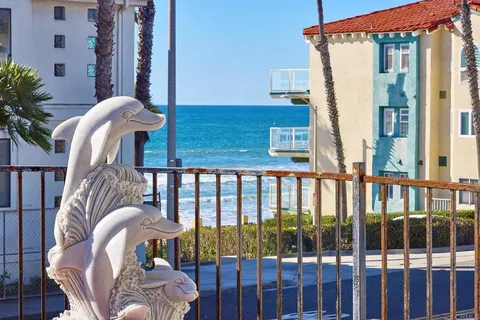 a balcony view with a large window and wooden floor