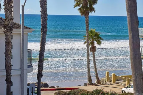 a vase of flowers sitting on a table next to a window