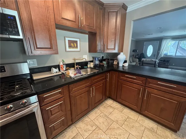 a kitchen with granite countertop a sink and cabinets