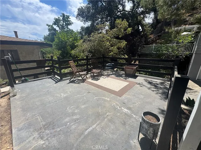 a view of backyard with outdoor seating and trees